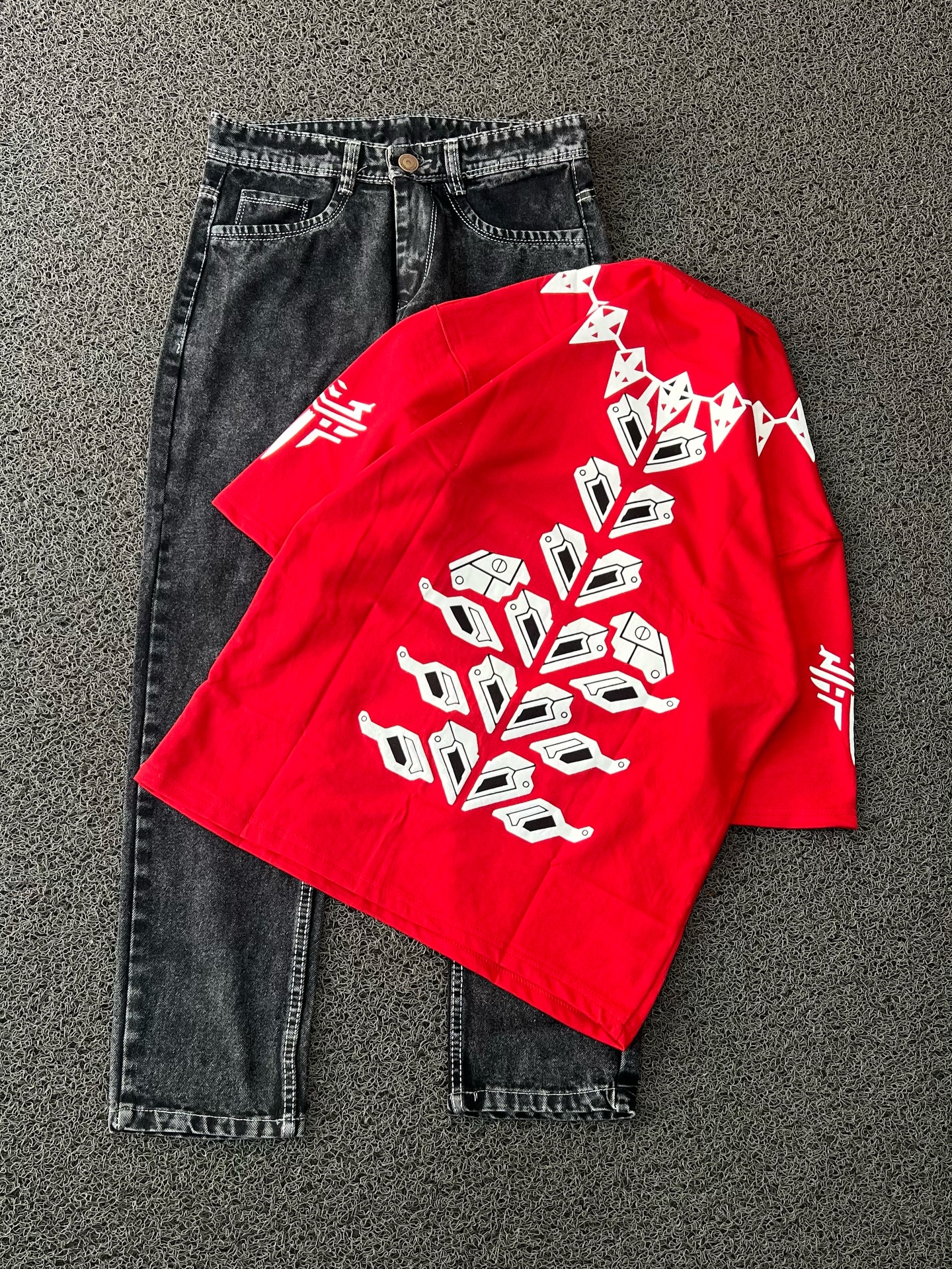 Street-Ready Statement: Red Oversized T-Shirt with White Geometric Graphic Print & Black Jeans