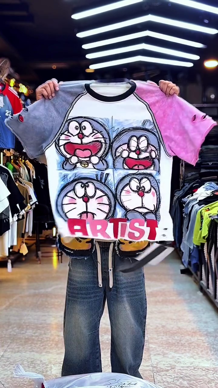 Playful Edge: Doraemon Graphic T-Shirt with “Artist” Print and Distressed Sleeves