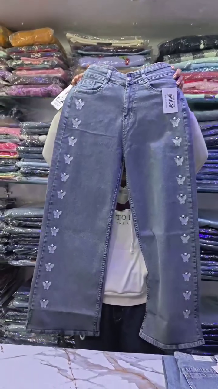 Whimsical Street Style: Wide-Leg Blue Denim Jeans with Butterfly Embellishments