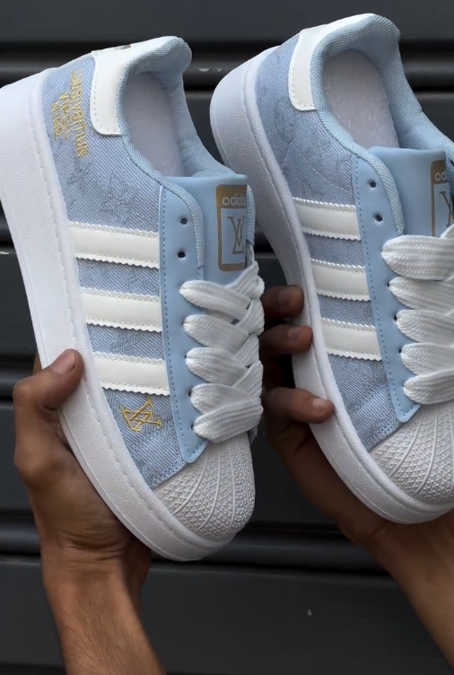 Custom-Style Street Icon: Adidas Superstar Sneakers in Light Blue & White with Decorative Branding
