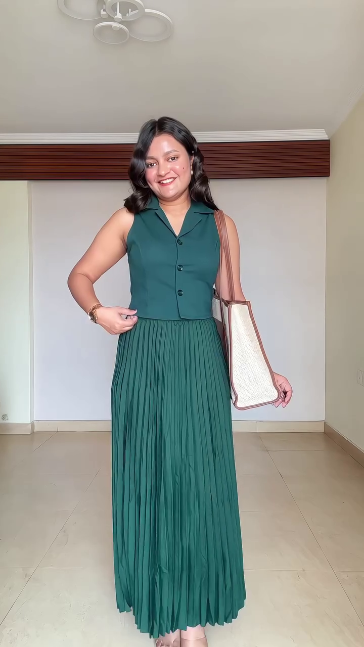 Chic Minimalism: Sleeveless Black Top with White Trim Paired with Trousers