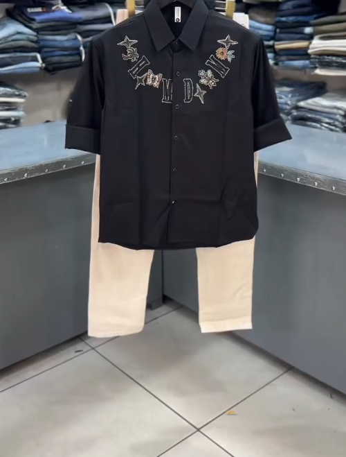 Bold Party Chic: Black Embroidered Shirt with Light Baggy Jeans