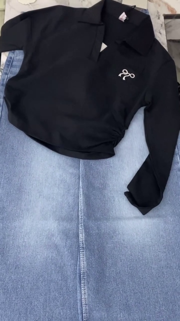 Stylish Black Long-Sleeve Polo Shirt with Minimal Embroidered Logo Paired with Light Blue Straight-Leg Jeans