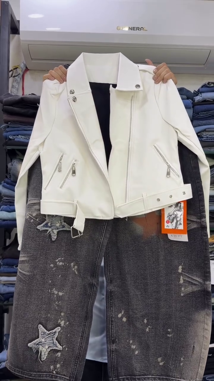 Trendy White Faux Leather Biker Jacket with Silver Zipper Details Paired with Distressed Grey Wide-Leg Jeans